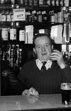 Image of John Callaghan behind the bar.